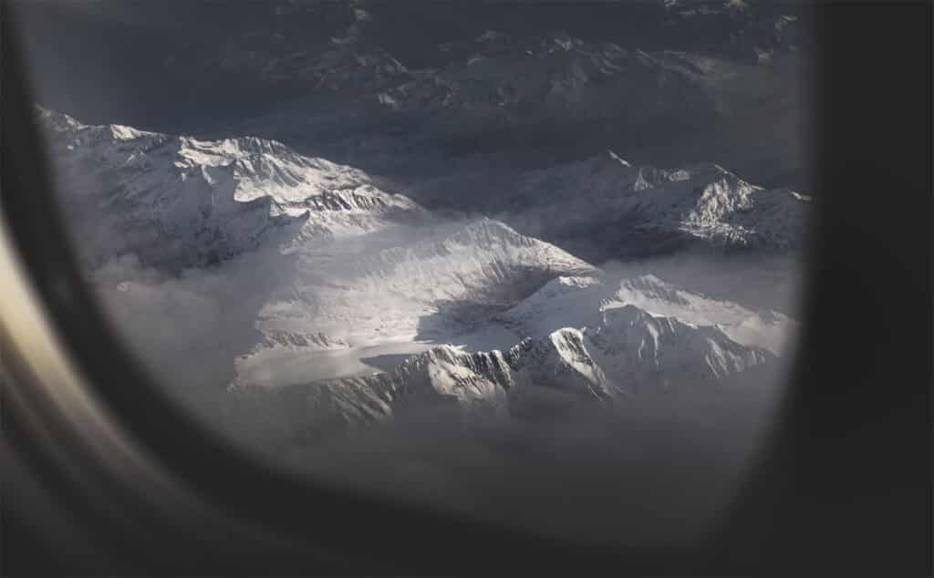 airplane flying over the alps